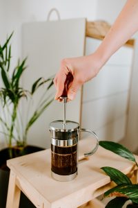 pressing plunger down french press